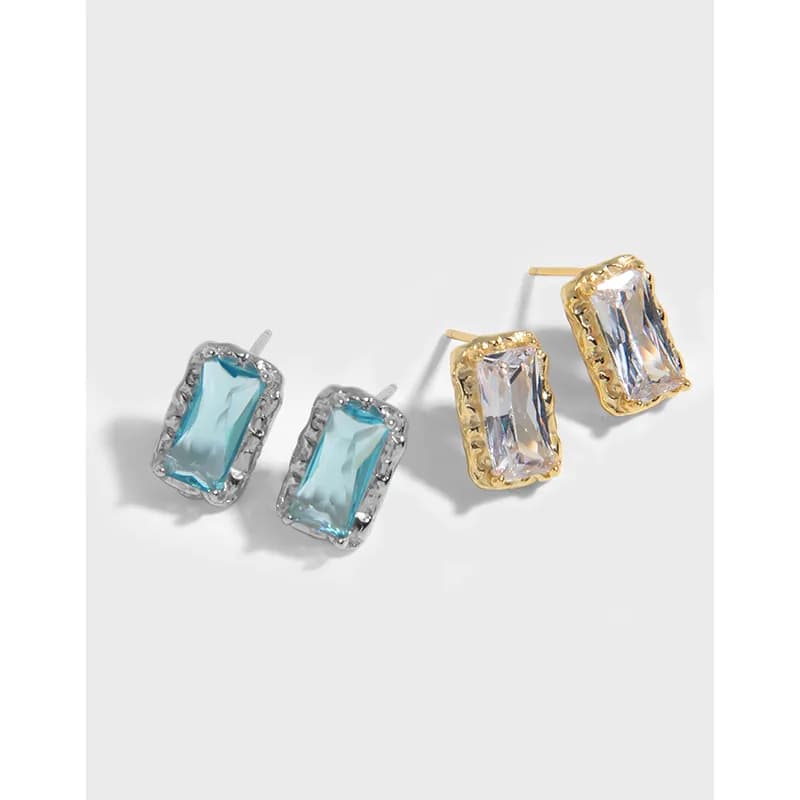 Pair of rectangular emerald-cut halo earrings in silver and gold-tone settings with pavé crystal halos.
