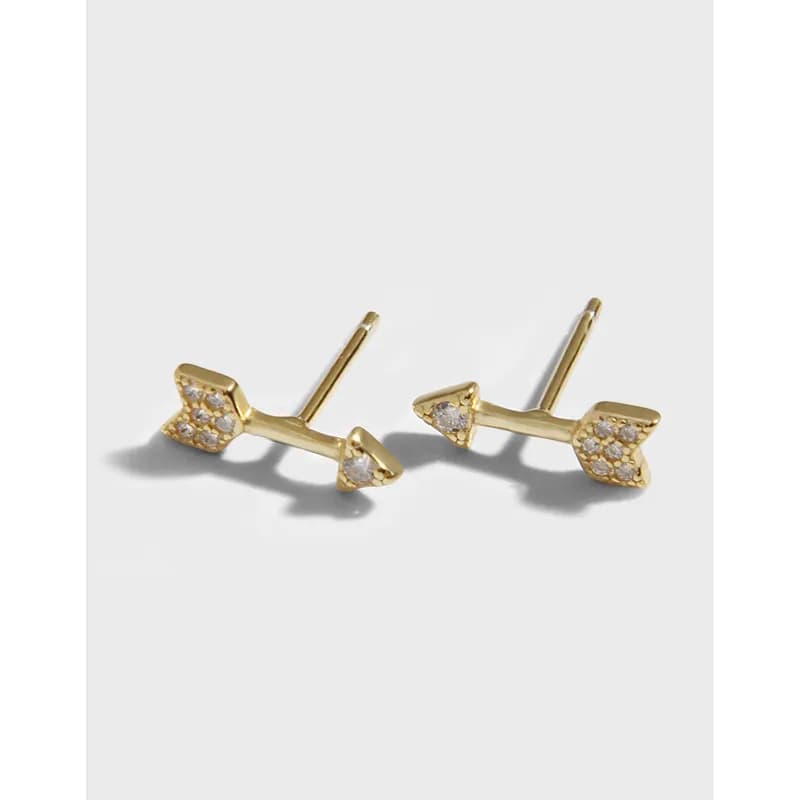 Polished sterling silver branch stud earrings with stone-clad leaf ends lay flat on a white surface.