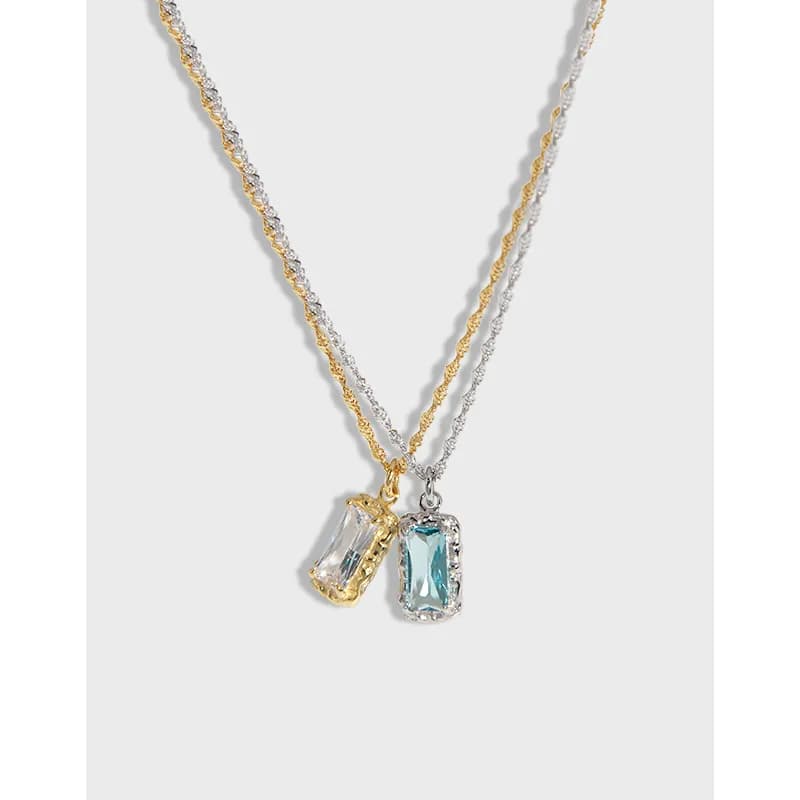 Two-tone necklace with dual rectangular gemstone pendants on a polished mixed-metal chain.