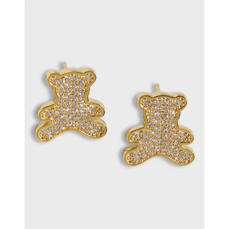 Polished sterling silver teddy bear earrings with crystal pavé set on a light background.