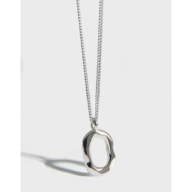 Sterling silver necklace with an irregular open-ring pendant on a delicate chain.