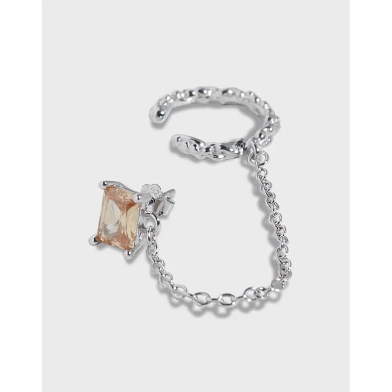 Polished sterling silver earring with a square peach gemstone and a short chain detailing.