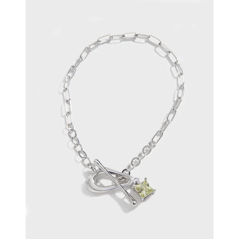 Sterling silver chain bracelet featuring a bar toggle clasp and a small pale star gemstone charm.