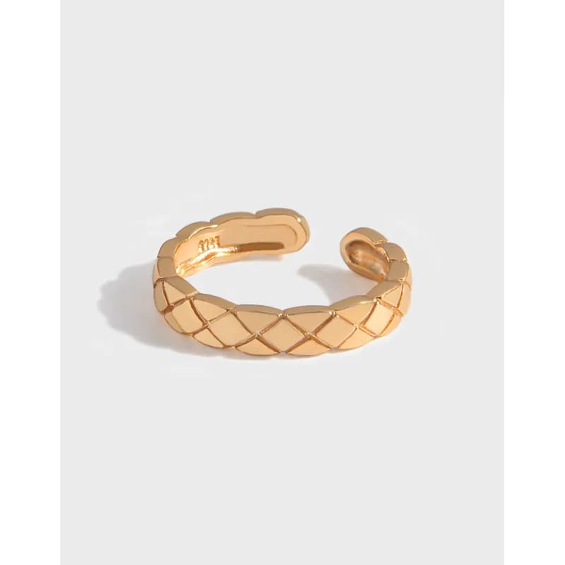 Polished sterling silver quilted lattice ring with an open gap and diamond-pattern panels.