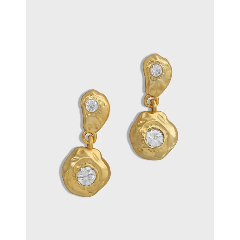 Polished sterling silver hammered drop earrings with crystal centers and organic shapes.