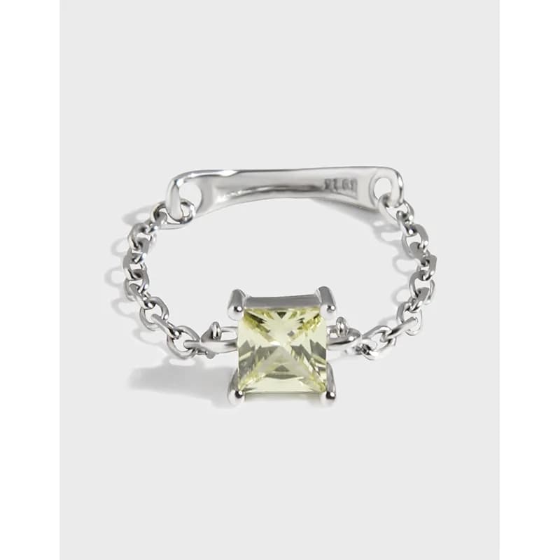Polished sterling silver ring with a square-cut stone held in a four-prong setting and a chain-link band.