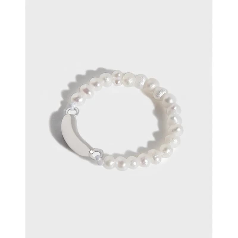 Close-up of a sterling silver pearl bead ring with a curved front plate