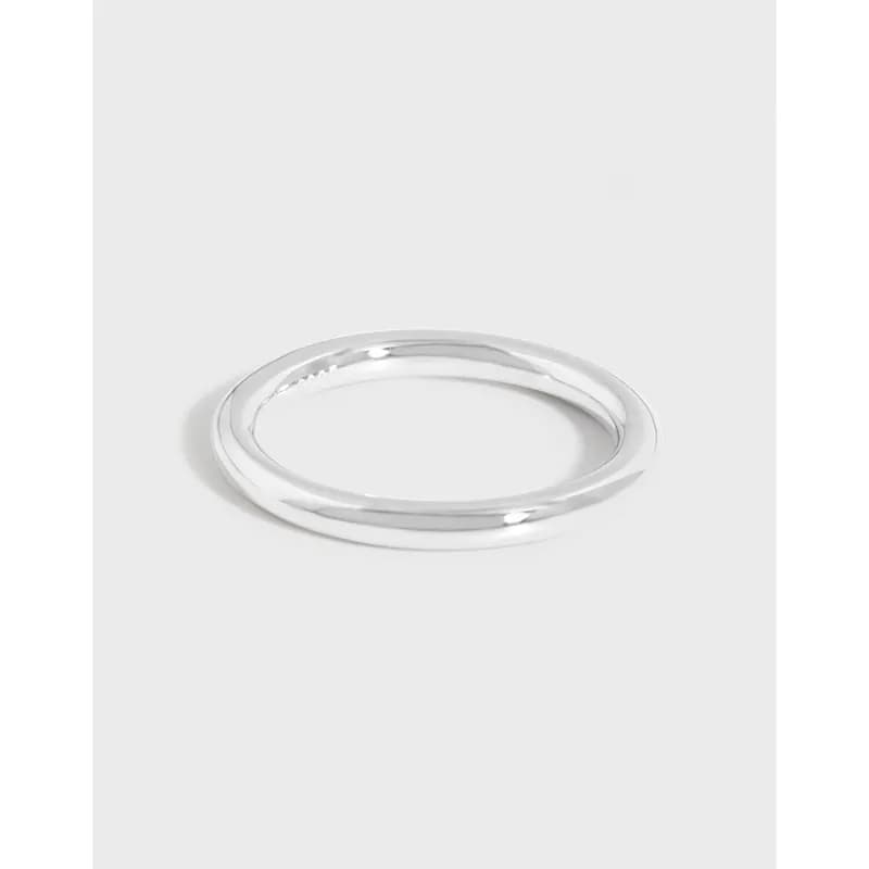 Polished sterling silver double-band ring photographed on a light neutral background.