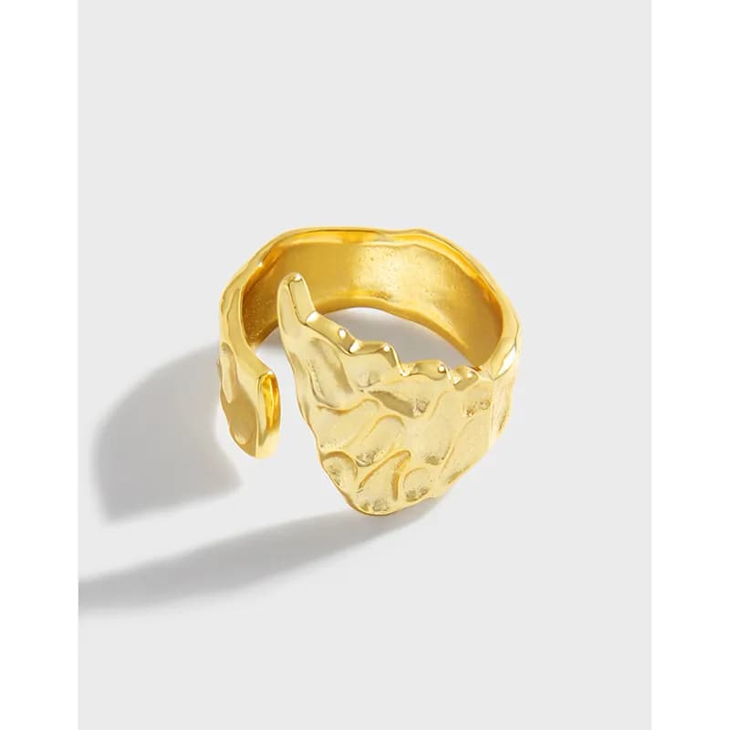 Wide textured sterling silver ring with an open wrap and hammered detailing on the front.