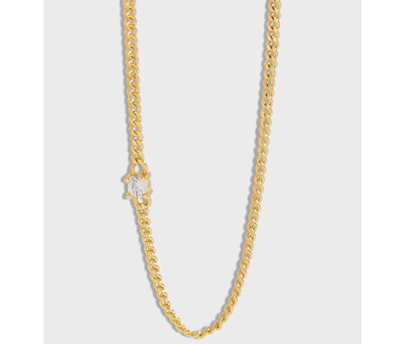 Polished necklace with a small solitaire diamond pendant on a delicate chain.