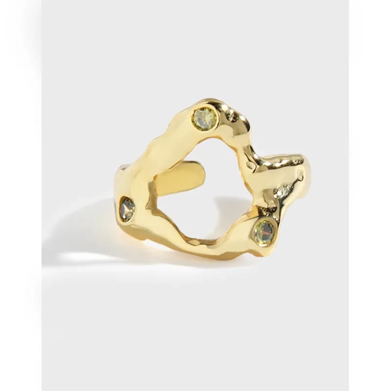 Polished sterling silver organic silhouette ring with three small stones set along the uneven edge.