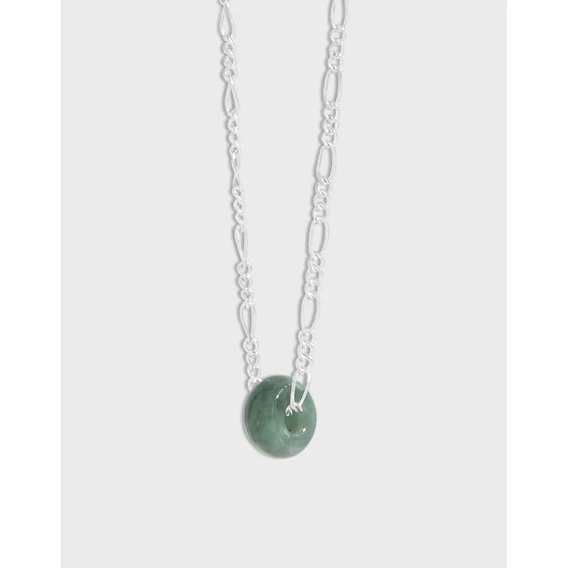 Silver chain necklace with a round green stone pendant