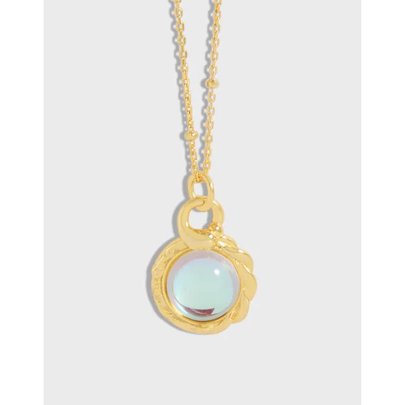 Polished sterling silver pendant with a round opalescent cabochon on a delicate beaded chain