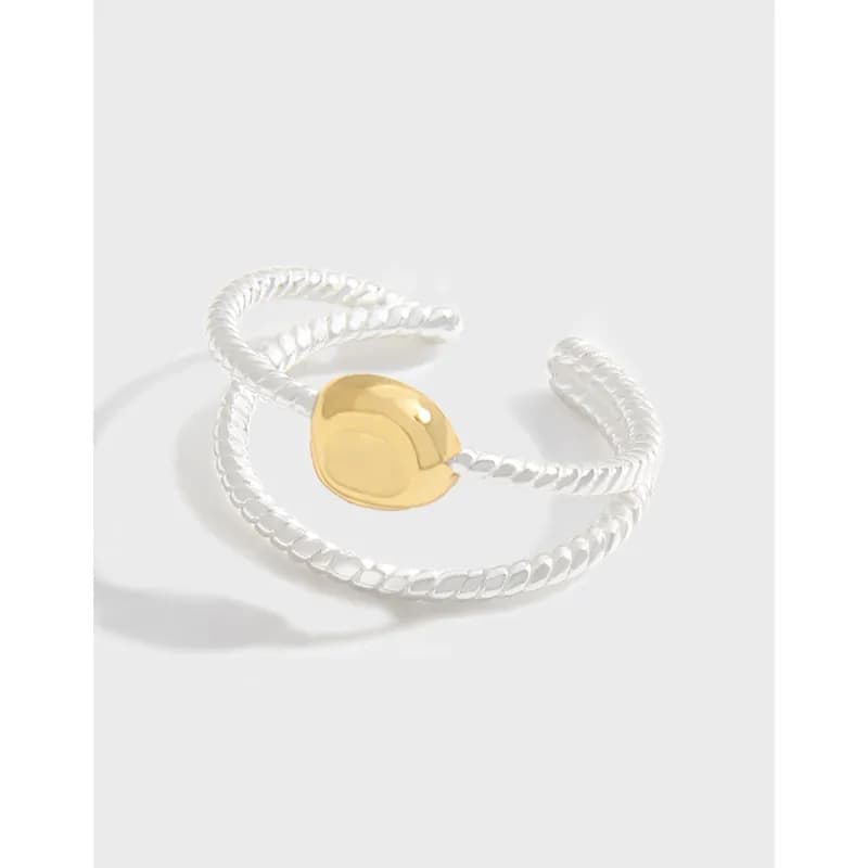 Polished sterling silver rope ring with a gold heart centerpiece in an open wrap design.
