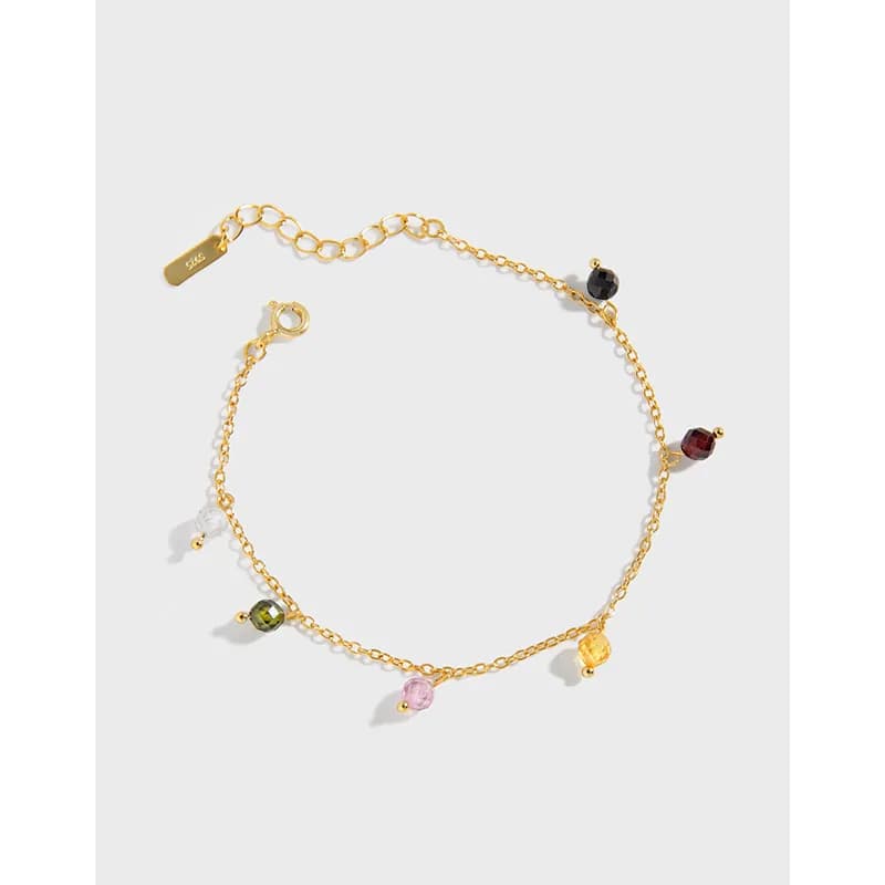 A delicate silver bracelet with small colorful beads spaced along a fine chain.