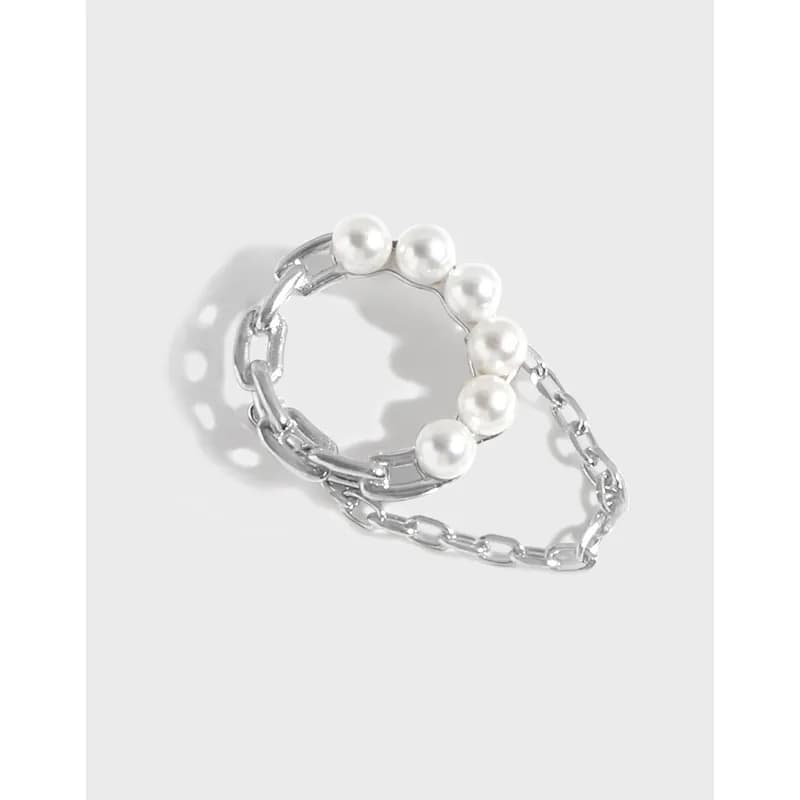 Polished sterling silver ring with a row of pearls around the circular band and a short accompanying chain.