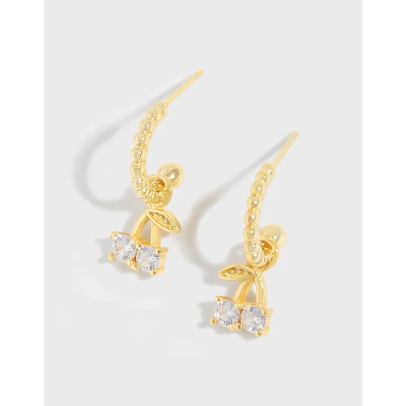 Polished sterling silver earrings with a curved hoop texture and a leaf motif drop with two clear stones.