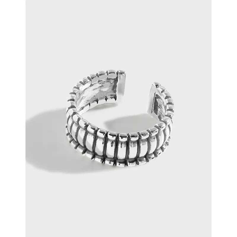 Polished sterling silver ribbed bead ring shown with an open back and shadow on a light surface.