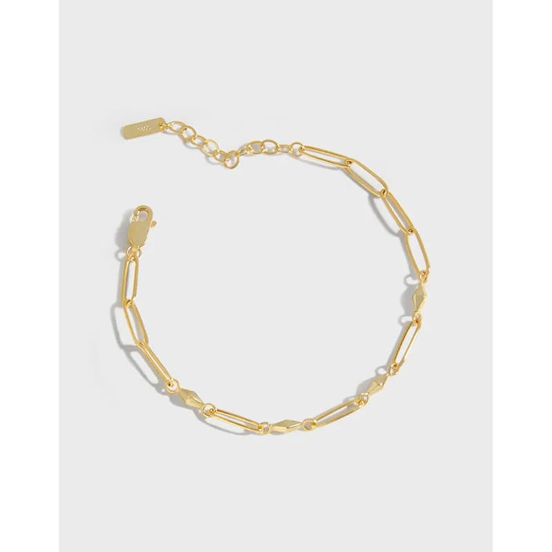 Polished sterling silver bracelet with elongated rectangular links and adjustable clasp laid out on a white background.
