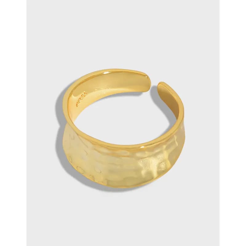 Polished sterling silver hammered wide ring with an open gap and smooth interior