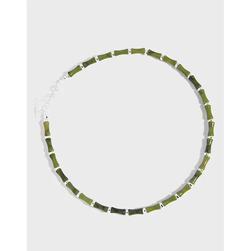 Polished sterling silver necklace with rectangular green beads spaced along the chain.