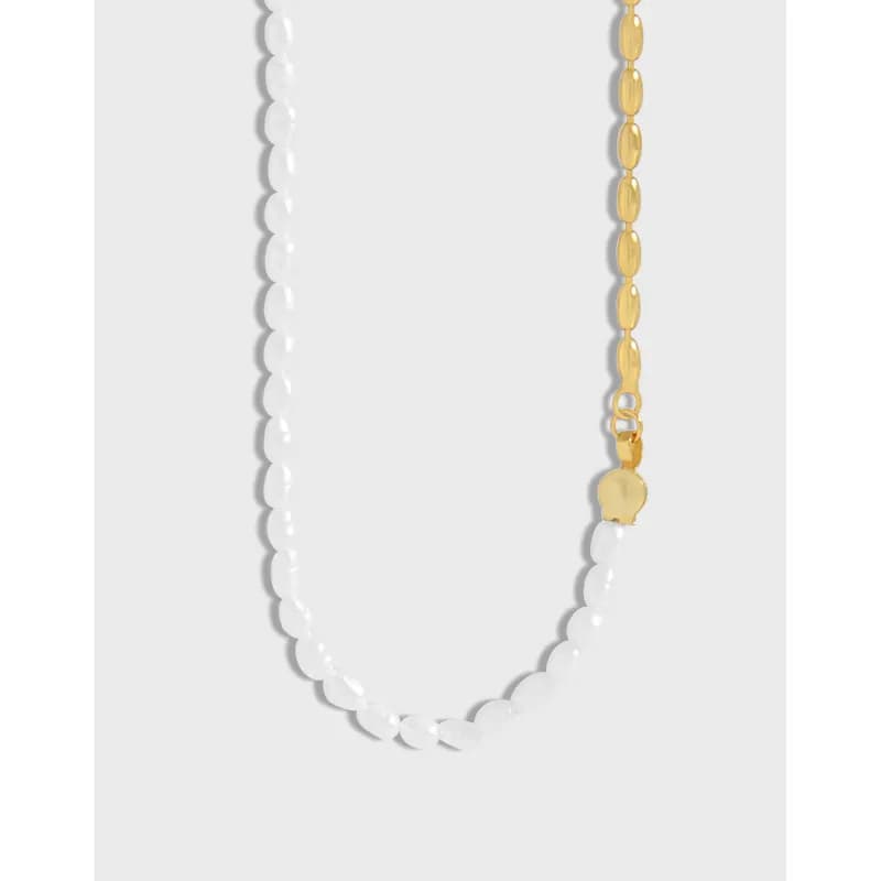 Polished two-tone beaded necklace with white beads and a gold-tone chain accent, shown in a curved, close-up view.