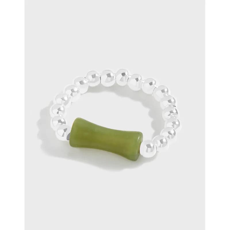 Polished sterling silver beaded ring featuring a green cylindrical stone centerpiece