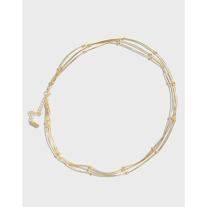 Polished sterling silver multi-strand necklace with small spacer beads shown laid flat