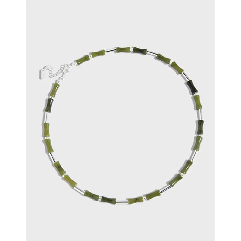 Sterling silver necklace with irregular olive-green beads arranged along a slim chain.