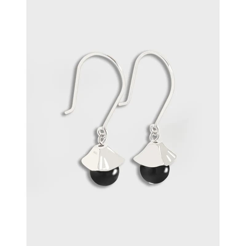 Polished sterling silver drop earrings with curved hooks and a fan-shaped charm over a black bead.