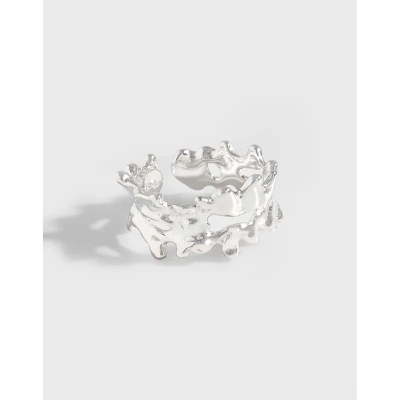 Matte sterling silver organic cuff earring with a jagged, coral-like design on a white background.