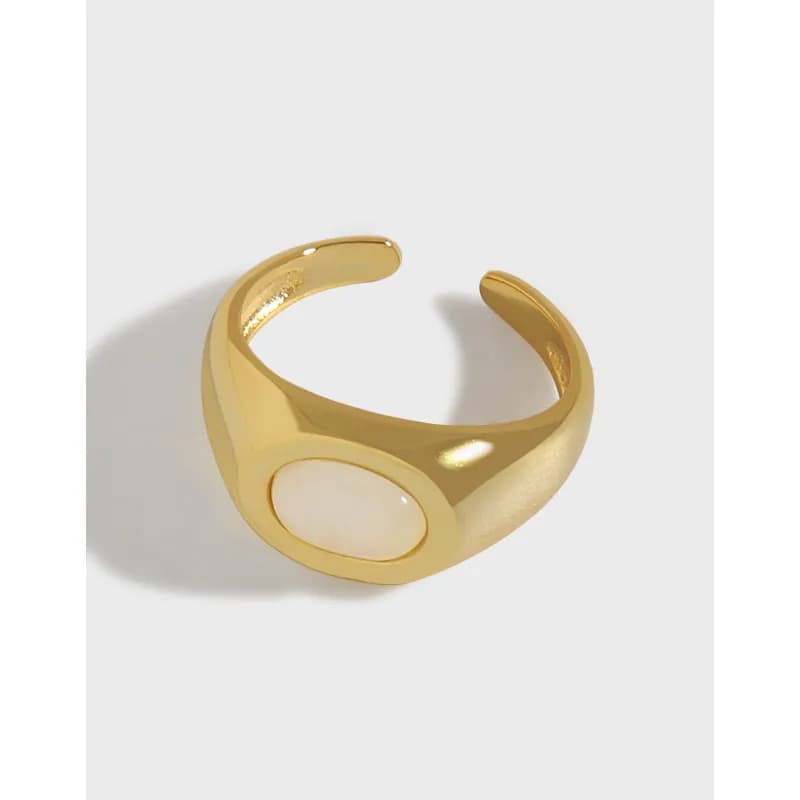Polished sterling silver ring with an oval white cabochon set in a smooth bezel
