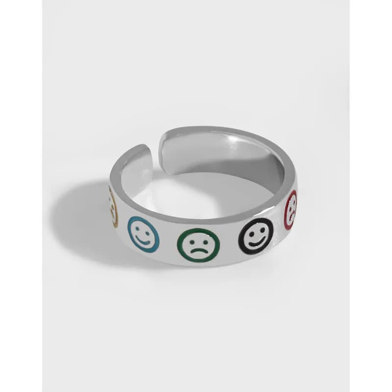 Polished silver open ring with multicolor enamel smiley faces around the exterior.