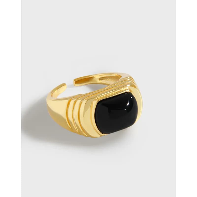 Polished silver ring with a large black cabochon set in a stepped bezel