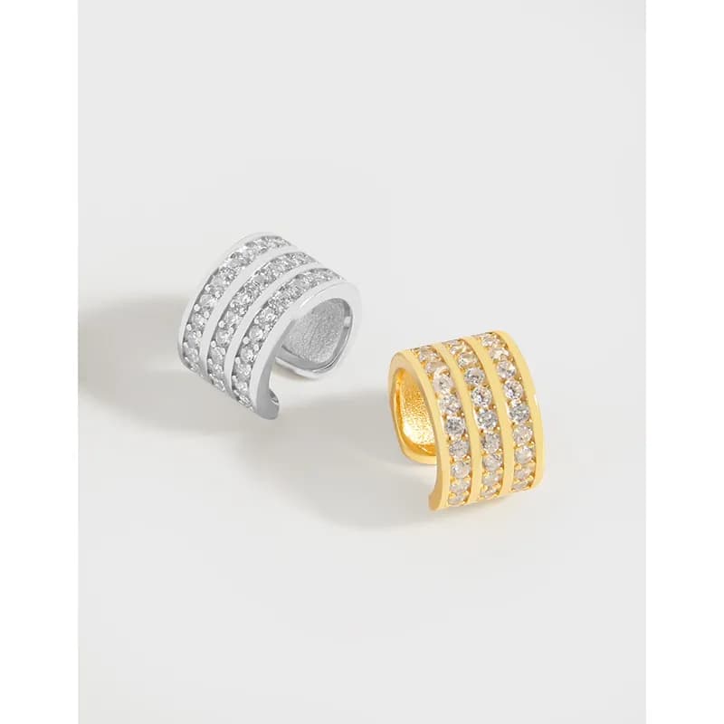 Two-tone pavé hoop earrings with three crystal-studded bands in silver and gold finishes