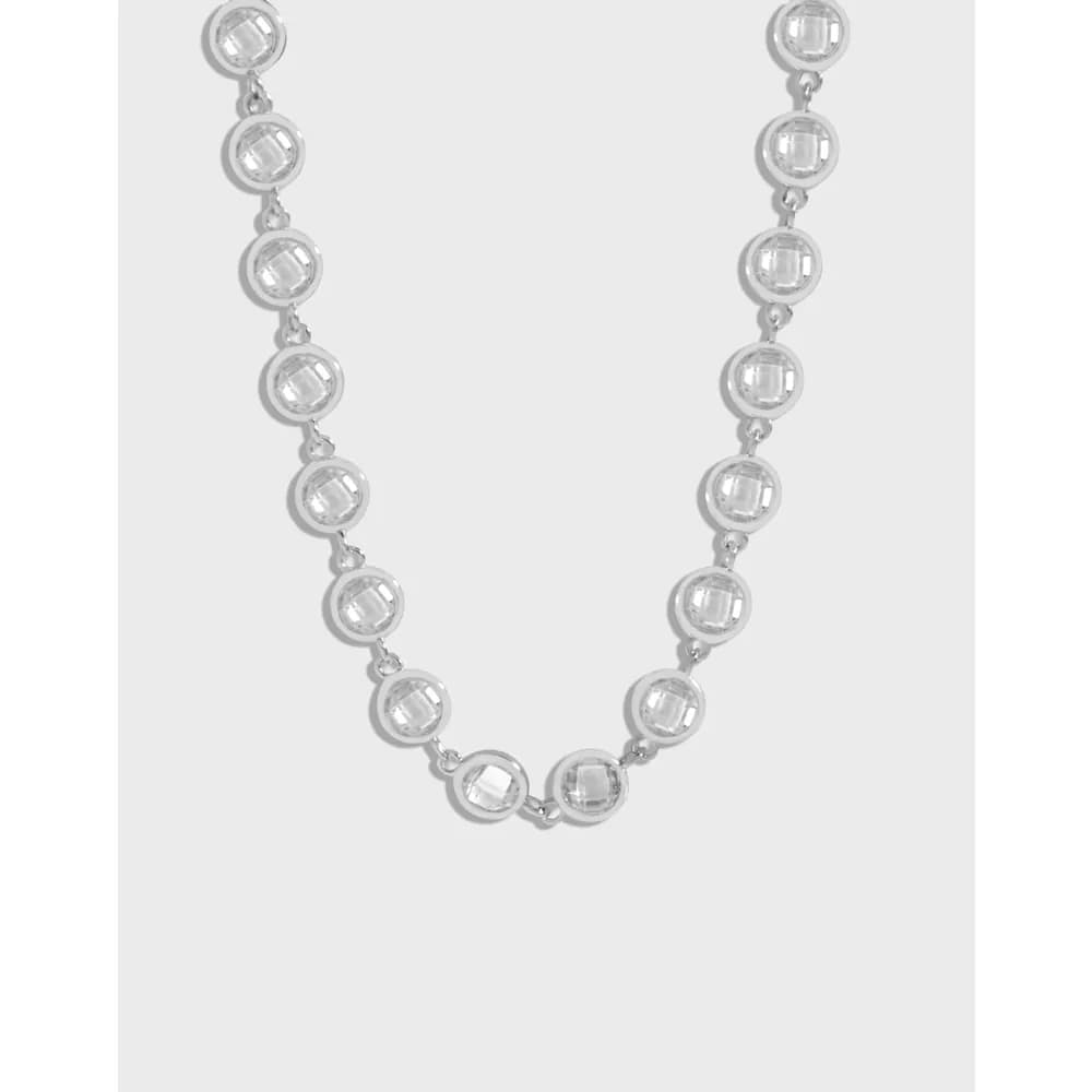 Polished sterling silver necklace with round bezel-set discs along a delicate chain.