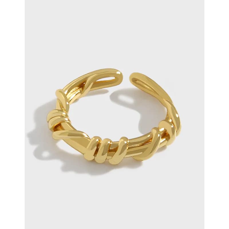 Polished sterling silver knot ring with rope-like twists on a white background.