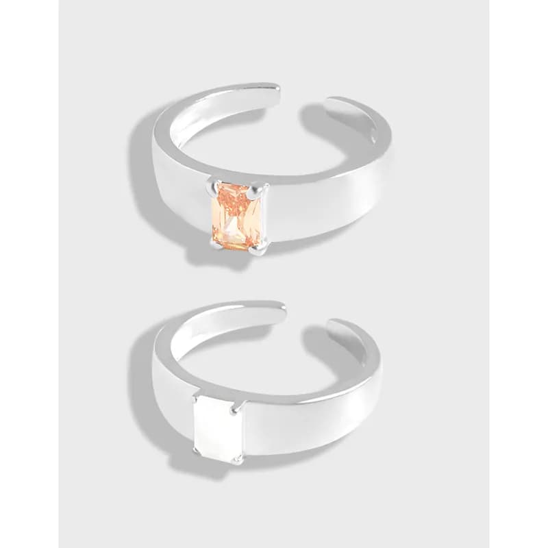Two polished sterling silver rectangular gemstone cuff rings shown from the side with open gaps and prong-set stones.