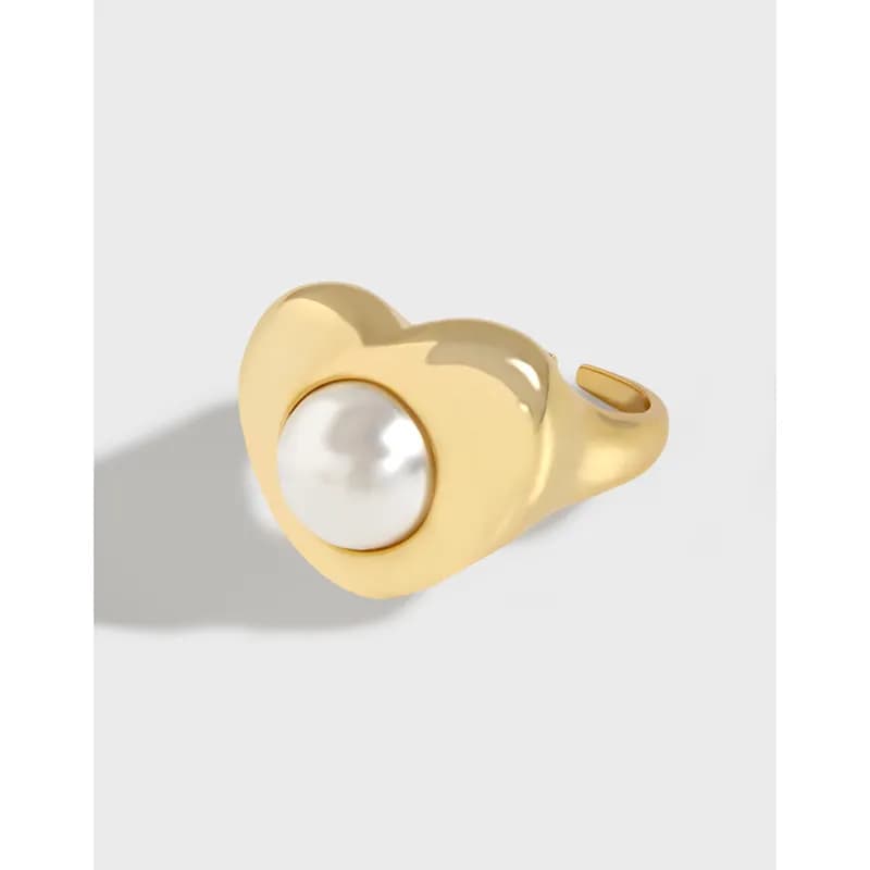 Polished silver ring with a single white pearl bezel-set centerpiece