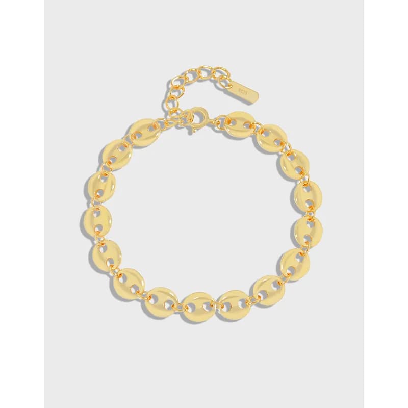 Polished sterling silver disc-link bracelet with extender chain on a neutral background.