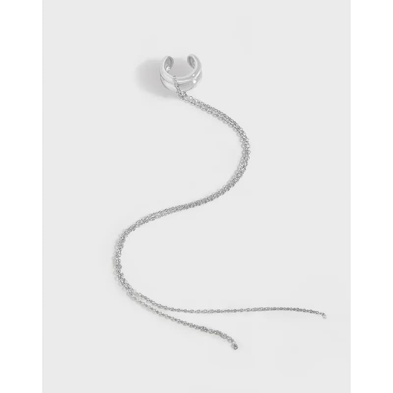 Polished sterling silver cuff earring with a trailing delicate chain
