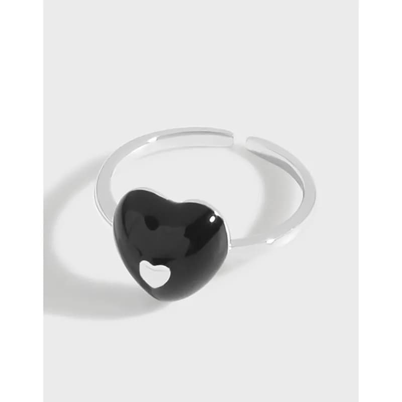 Polished sterling silver ring with a black heart Cabochon and open band style.