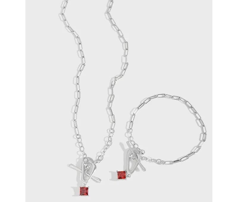 Polished Sterling Silver Necklace with a square red gemstone pendant on an elongated chain.
