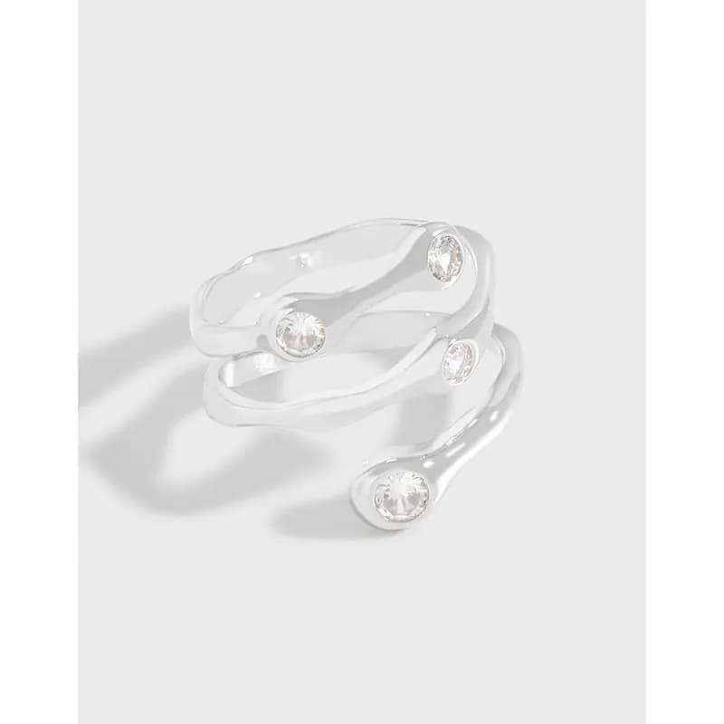 Polished sterling silver wavy ring with multiple bezel-set gemstones along the ends.