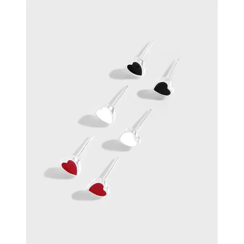 Polished sterling silver heart-shaped stud earrings with red, black, and white enamel on a light background.