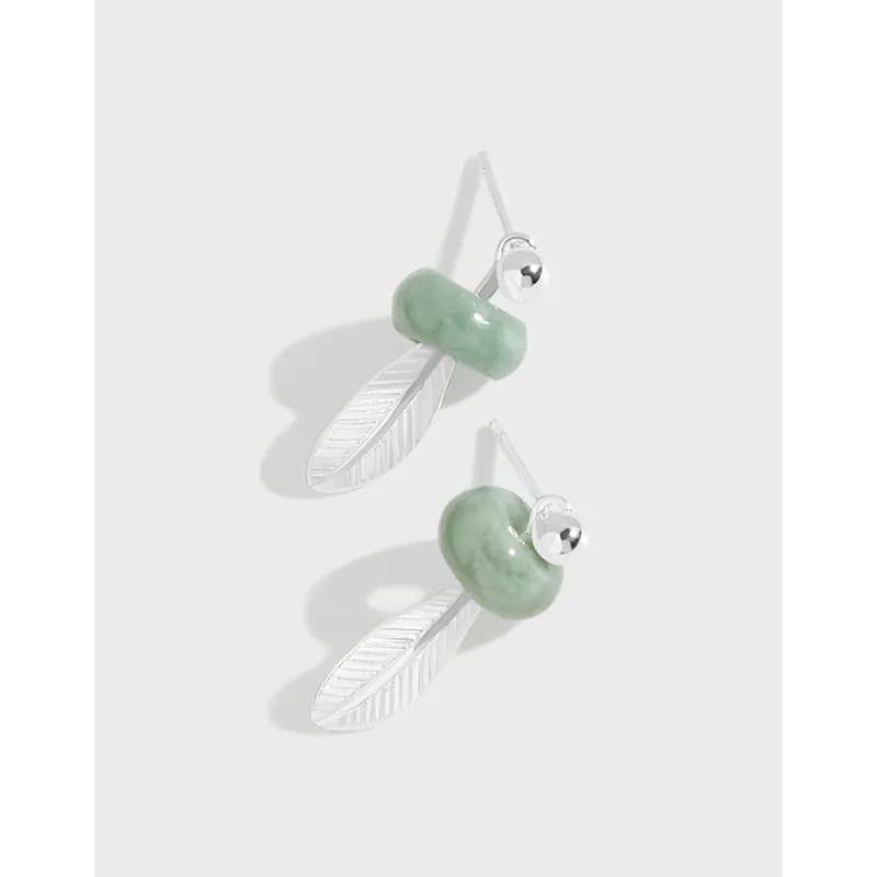 Sterling silver earrings with a polished leaf charm and pale green jade bead