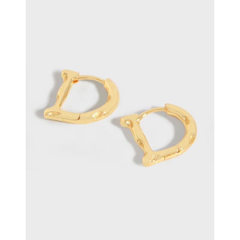 Polished sterling silver bamboo-inspired hoop earrings with hinged clasps on a light background.