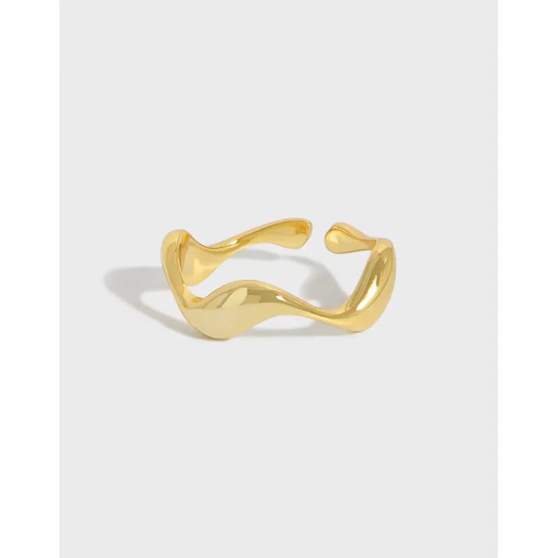 Polished, gold-toned wavy open-ring with a fluid, sculpted silhouette resting on a white background.