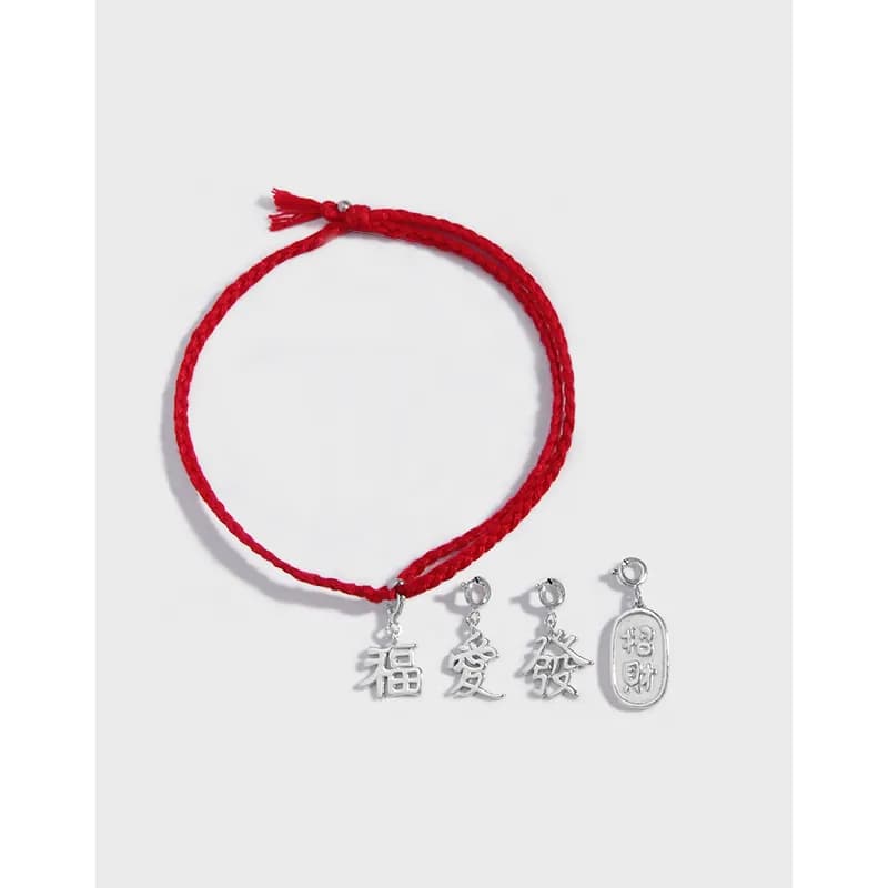 Red braided bracelet with three silver Chinese character charms and a small tag charm on a white background.