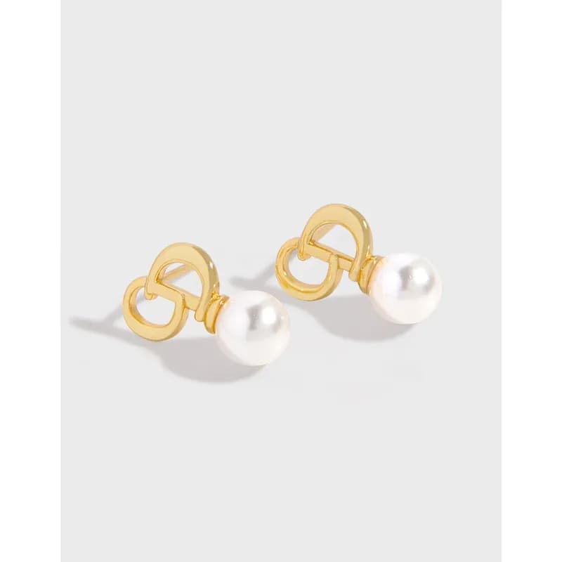 Polished sterling silver pearl stud earrings with a circular loop detail